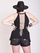 black tank with sheer back panel embroidered with spine motif