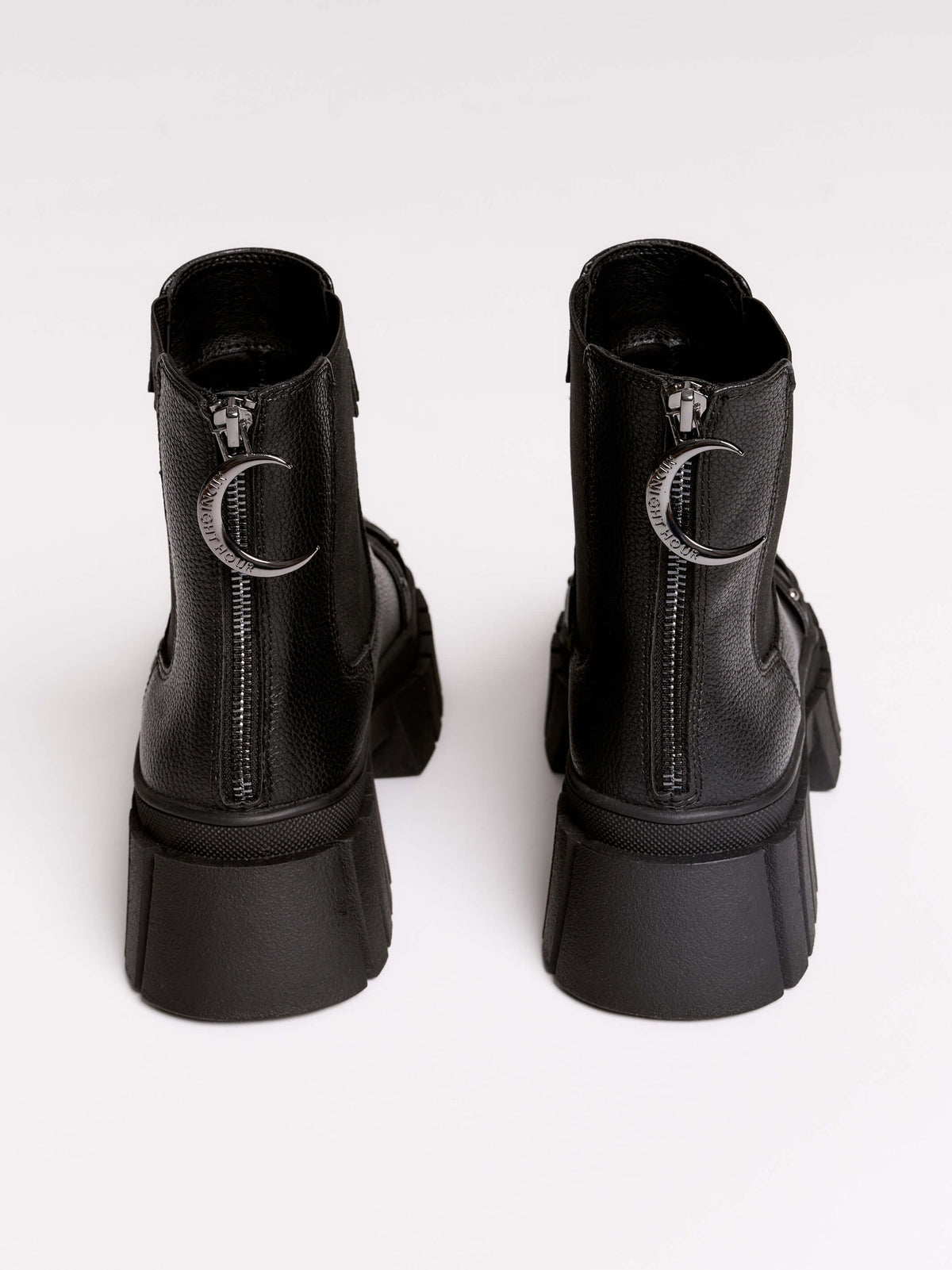 Black chunky platform ankle boots with buckle straps.