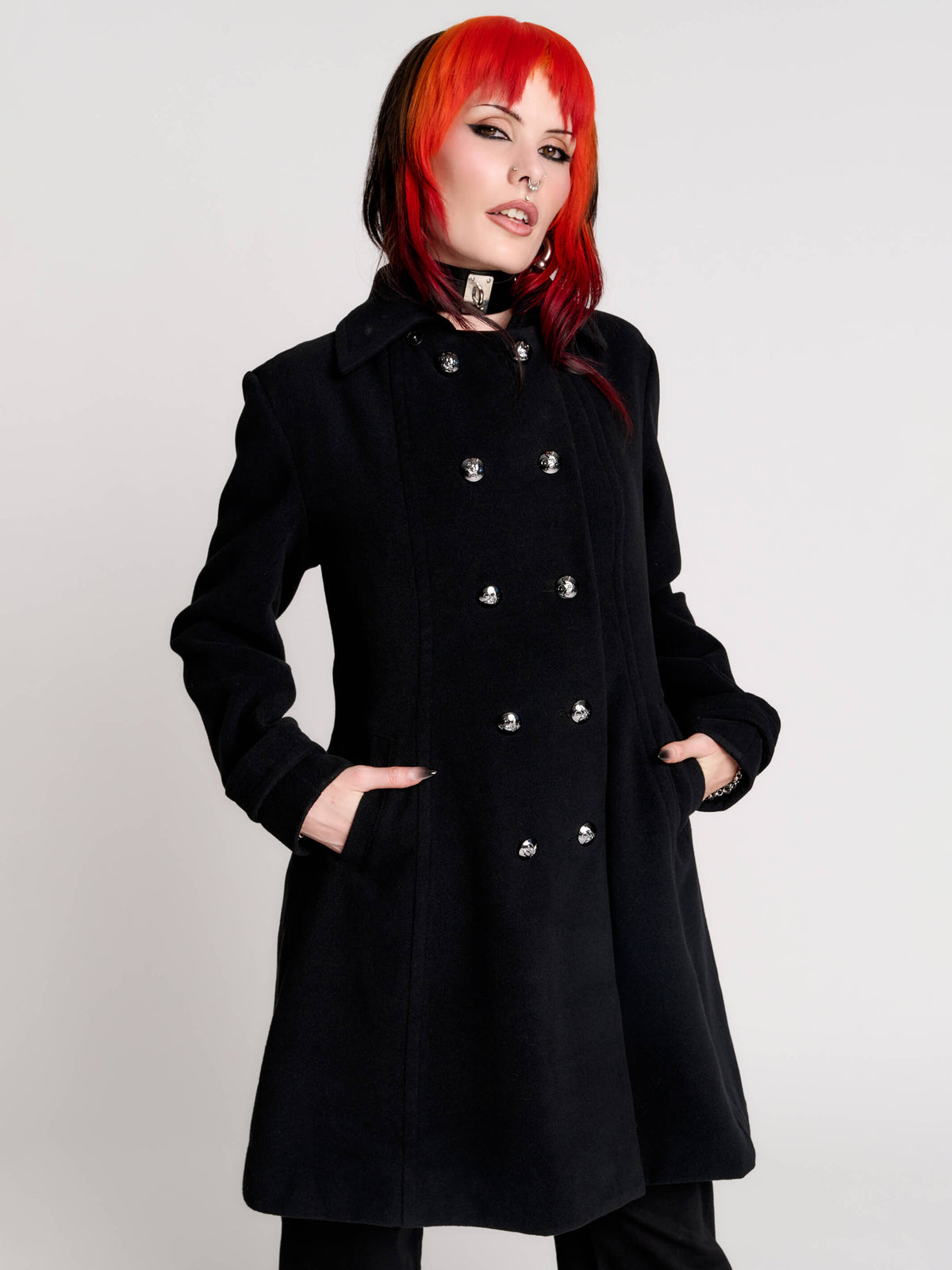 a black double-breasted coat with silver buttons