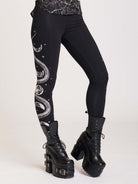 Black legging with skeleton snake and moon phase graphibs down the sides.