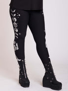 BLACK LEGGING WITH WHITE GRAPHIC FEATURING PRAYING SKELTON AND MOON PHASE