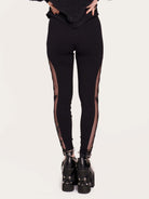 Embroidered mesh side panel on black legging