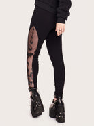 Embroidered mesh side panel on black legging