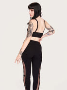 Embroidered mesh side panel on black legging