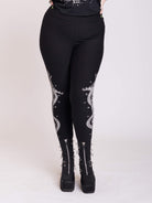 black legging with snake and dagger graphic on side